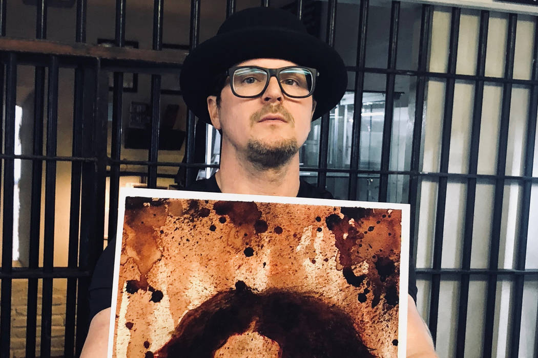 Zak Bagans of "Ghost Adventurers" on Travel Channel shows a painting of Charles Manson, with Manson's ashes used for the eyes, at Zak Bagans' Haunted Museum on Saturday, July 28, 2018. (Zak Bagans ...
