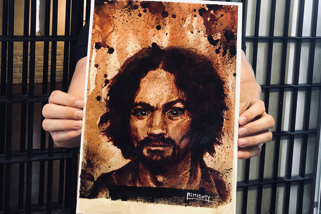 Zak Bagans of "Ghost Adventurers" on Travel Channel shows a painting of Charles Manson, with Manson's ashes used for the eyes, at Zak Bagans' Haunted Museum on Saturday, July 28, 2018. (Zak Bagans ...