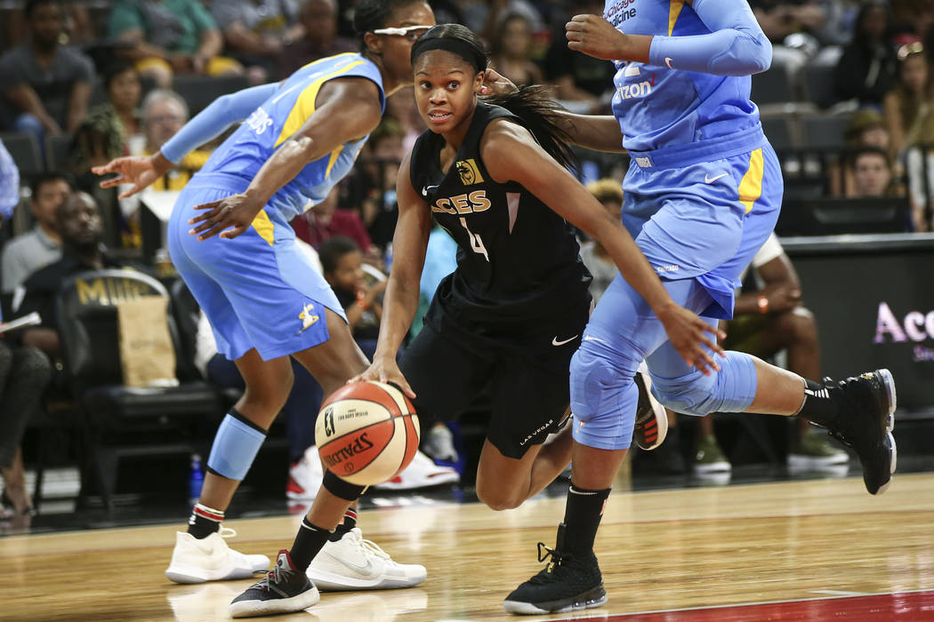 Las Vegas Aces guard Moriah Jefferson (4) drives the ball in front of Chicago Sky forward Cheyenne Parker (32) during the second half of a WNBA basketball game at Mandalay Bay Events Center in Las ...