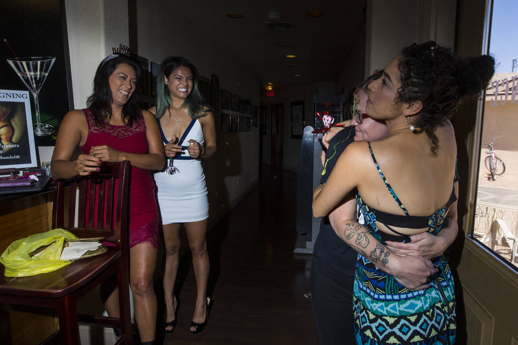 Prostitute Dasha Dare, far right, hugs "house mom" Jackie Williams as coworkers Cee M ...