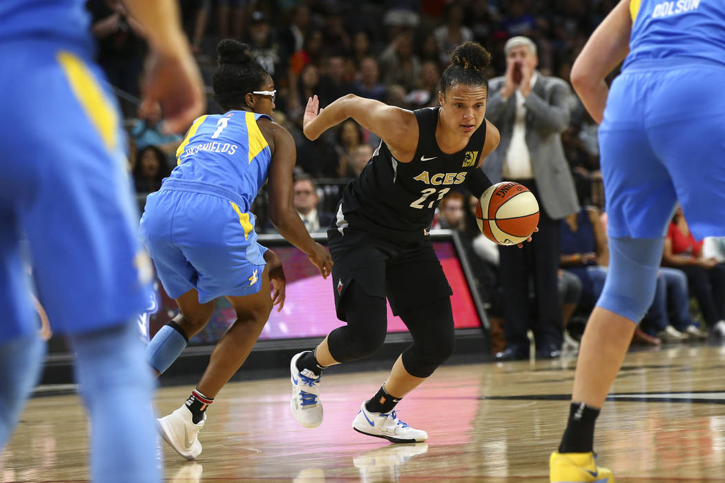 Las Vegas Aces guard Kayla McBride (21) drives past Chicago Sky guard Diamond DeShields (1) during the second half of a WNBA basketball game at Mandalay Bay Events Center in Las Vegas on Thursday, ...