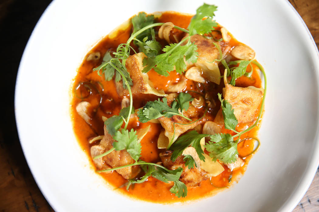 The scallop and shrimp dumplings are served with sudado stew sauce and crispy garlic, at the Palazzo hotel-casino in Las Vegas, Wednesday, Aug. 1, 2018. Erik Verduzco Las Vegas Review-Journal @Eri ...