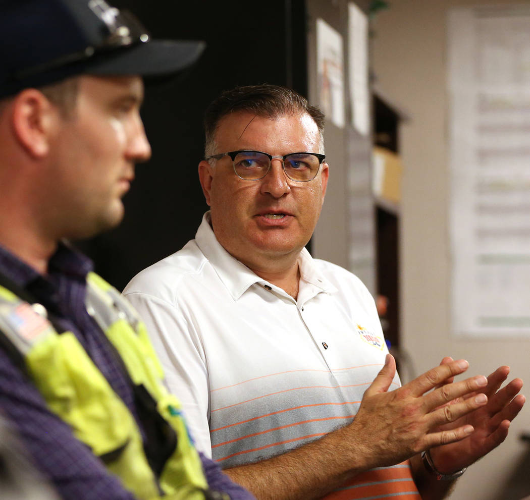 Kiewit's safety manager Robert Murphy, left, and public information officer Jay Proskovec, discuss heat safety for their workers in the Nevada Department of Transportation Project Neon at a Kiewit ...