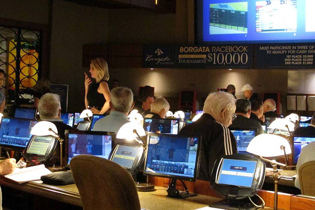 Bettors wait to make wagers on sporting events at the Borgata casino in Atlantic City, N.J., hours after it began accepting sports bets on June 14. (AP Photo/Wayne Parry, File)