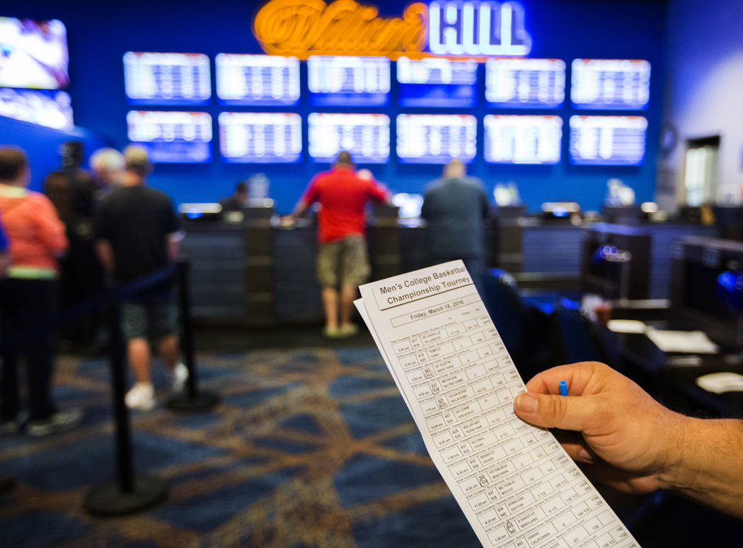 Wes Dorner from Green Bay, Wis. checks a parlay card for the NCAA Men's basketball in the William Hill Race & Sports Book at the Plaza Hotel-Casino on Friday, March 18,2016. Jeff Scheid/Las Vegas ...