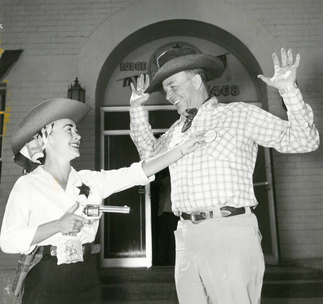 Margo Hines, Helldrado Beauty Queen, was commissioned a Kangaroo Kop by Elks Exalted ruler George Maxwell in May 1955 and makes a mock arrest of Lt. Gov. Rex Bell. (View file photo)