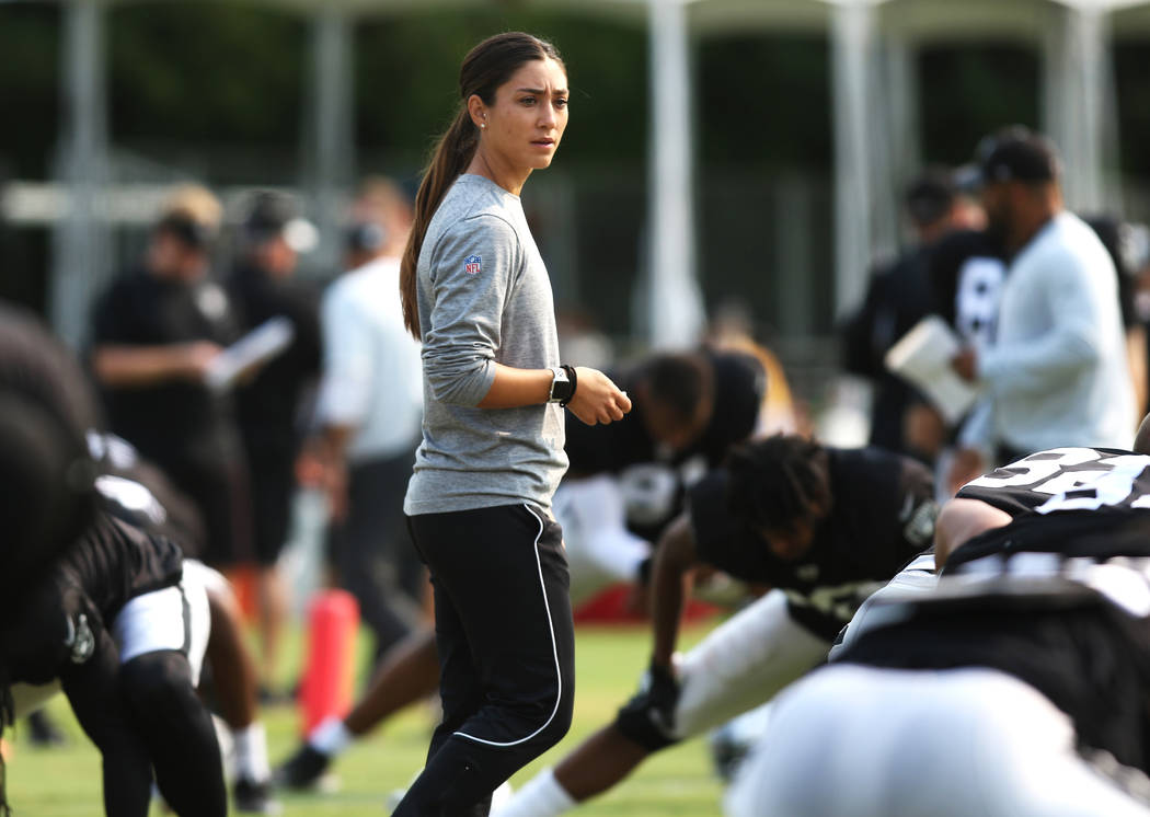 Oakland Raiders strength and conditioning assistant Kelsey Martinez puts the team through warm up stretches at the team's NFL training camp in Napa, Calif., Tuesday, Aug. 7, 2018. Heidi Fang ...