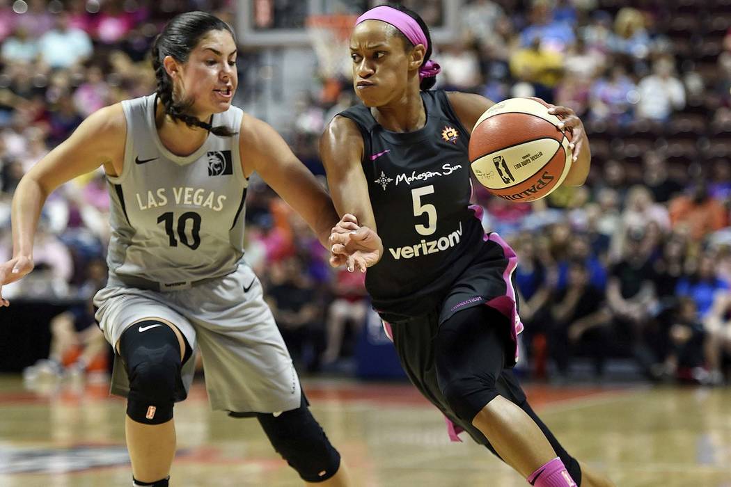 Connecticut Sun guard Jasmine Thomas (5) drives past Las Vegas Aces guard Kelsey Plum (10) in the first half half of WNBA basketball game action Sunday, Aug. 5, 2018, in Uncasville, Conn. (Sean D. ...