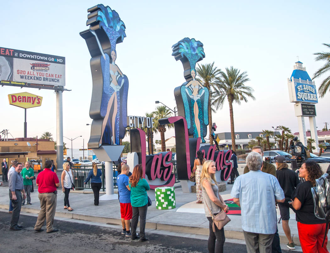 Attendees take a look at the new city of Las Vegas sign greeting visitors heading north on Las Vegas Boulevard near the Stratosphere on Tuesday, Aug., 7, 2018, in Las Vegas. Benjamin Hager Las Veg ...
