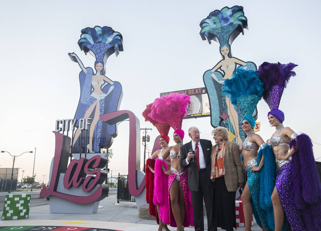 Las Vegas Mayor Carolyn Goodman, third from right, takes photos with her husband and former Las Vegas Mayor Oscar Goodman and a group of showgirls during a dedication ceremony for the new city of ...