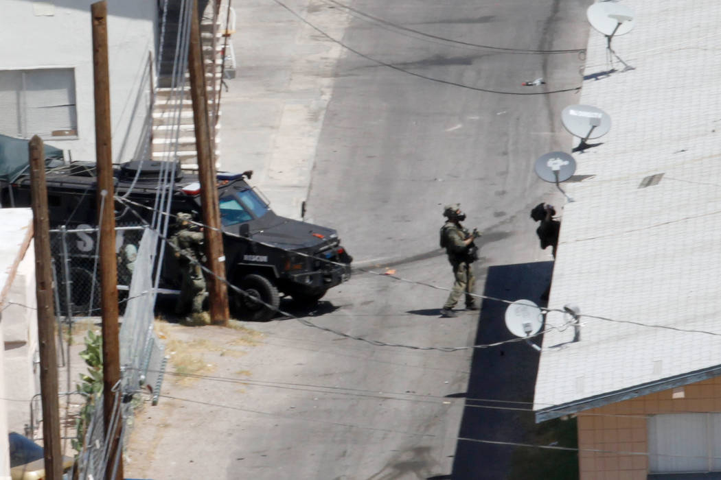 Las Vegas police and a SWAT team are seen around Baltimore Avenue in Las Vegas, Saturday, Aug. 4, 2018. According to Las Vegas police, a man barricaded inside of a downtown Las Vegas home early Sa ...