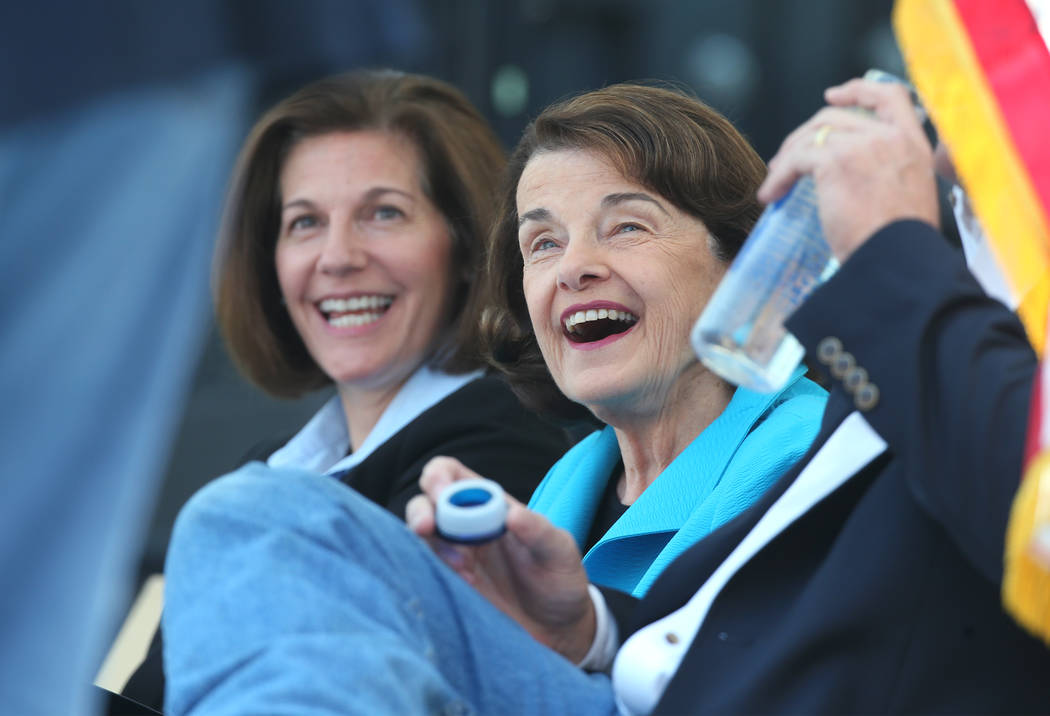 From left, U.S. Sens. Catherine Cortez Masto, D-Nev., and Dianne Feinstein, D-Calif., react to a speaker at the 22nd annual Lake Tahoe Summit, at Sand Harbor State Park, near Incline Village, Nev. ...