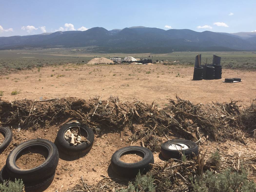 A makeshift shooting range stands adjacent to a disheveled living compound in Amalia, N.M., on Tuesday, Aug. 7, 2018. A New Mexico sheriff said searchers have found the remains of a boy at the mak ...