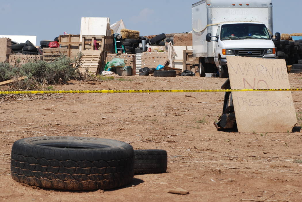 Police tape restricts access to a disheveled living compound in Amalia, N.M., on Tuesday, Aug. 7, 2018. A New Mexico sheriff said searchers have found the remains of a boy at the makeshift compoun ...