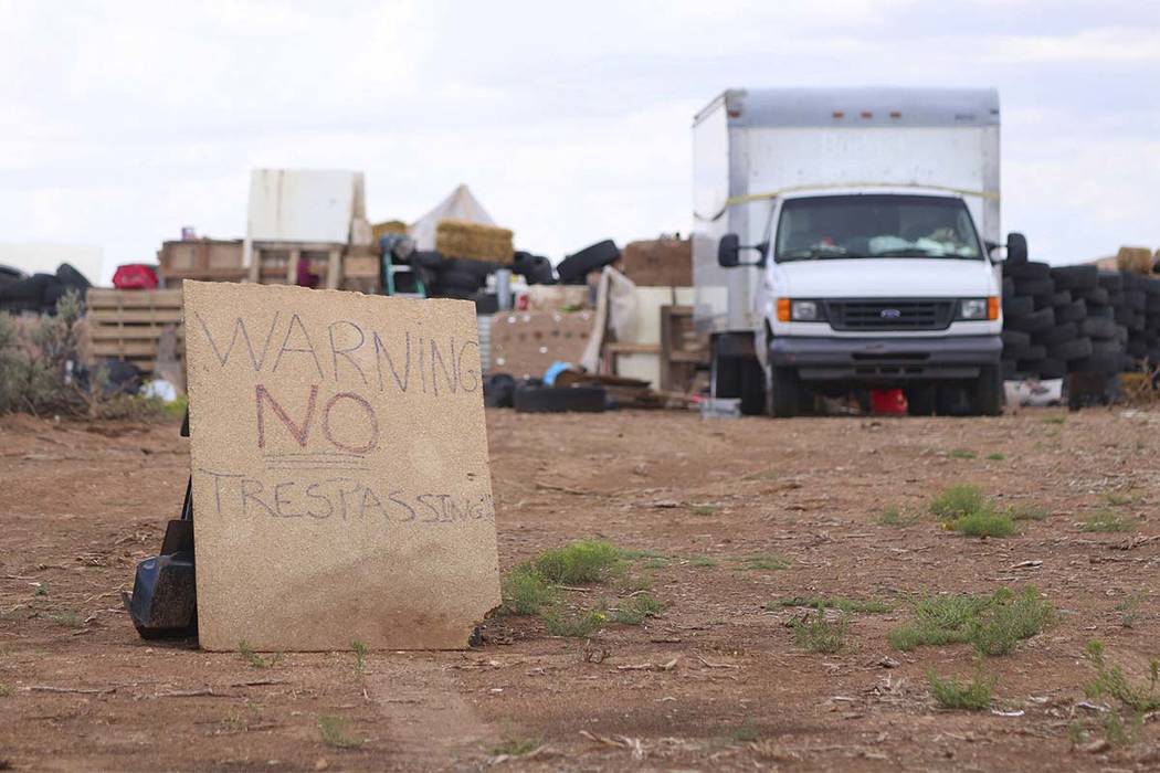 This Aug. 5, 2018 photo shows a "no trespassing" sign outside the location where people camped near Amalia, N.M. Three women believed to be the mothers of 11 children found hungry and li ...