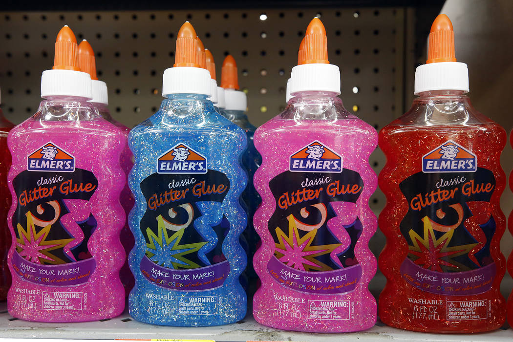 This July 19, 2018, photo shows a display of sparkle Elmer's glue in a  Walmart in Pittsburgh. Elmer's has been expanding beyond its famous white  school glue to purple, pink and blue