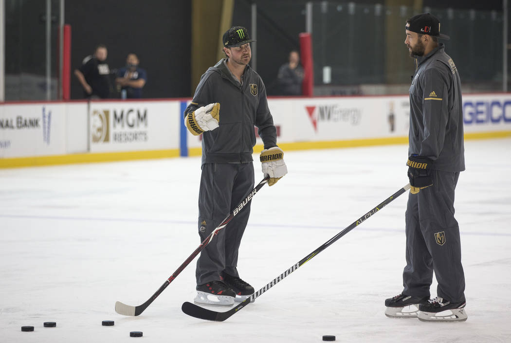 NASCAR driver Kurt Busch, left, takes hockey pointers from Vegas Golden Knights defenseman Deryk Engelland during a media event on Monday, Aug. 13, 2018, at City National Arena to promote the Sout ...
