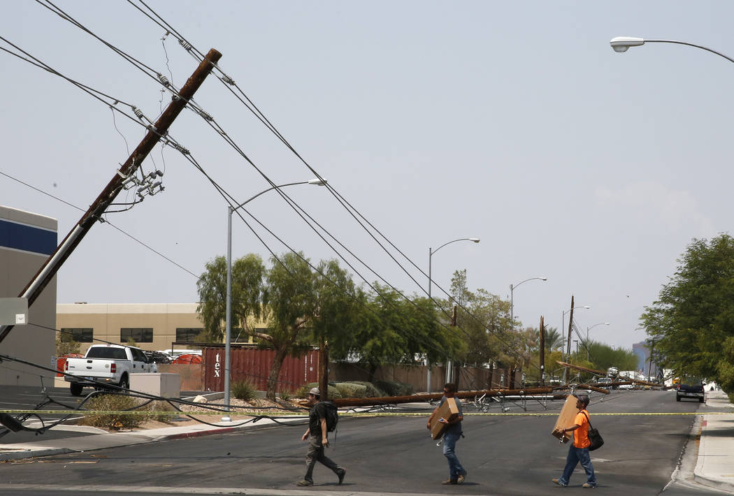 Pedestrians Walk Past Downed Power Lines At Sunset Rd And Polaris Ave On Friday Aug 10 2018 In Las Vegas Forklift Knocks Down 13 Power Poles Bizuayehu Tesfaye Las Vegas Review Journal B