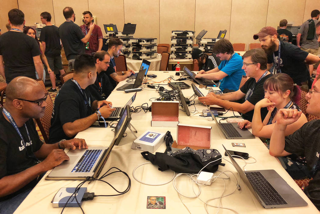 Cyber security enthusiasts and professionals trying to hack U.S. election equipment at DefCon conference at Caesars Palace on Friday. (Todd Prince/Las Vegas Review-Journal)