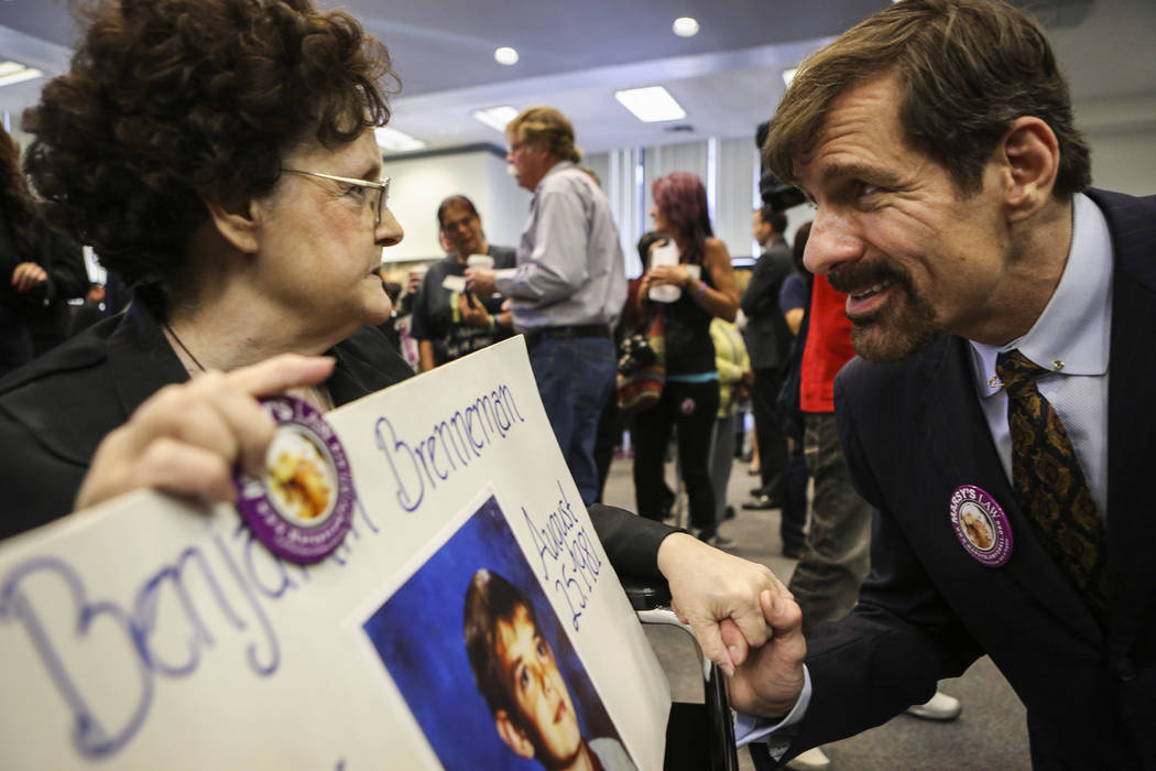 Henry Nicholas III speaks with the mother of a murder victim during a 2013 Orange County Victims' Rights March in Santa Ana, Calif. Nicholas is the chief architect of Marsy's Law, named for his si ...