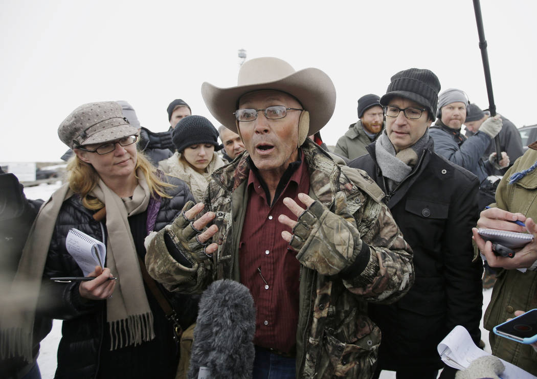 FILE - In this Jan. 5, 2016 file photo, Robert "LaVoy" Finicum, center, a rancher from Arizona, talks to reporters at the Malheur National Wildlife Refuge near Burns, Ore. A jury is deli ...