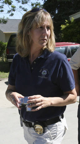 West Valley Code Enforcement Officer Jill Robinson checks a home for violations in West Valley City, Utah, in 2008. (Laura Seitz/The Deseret News via AP, File)