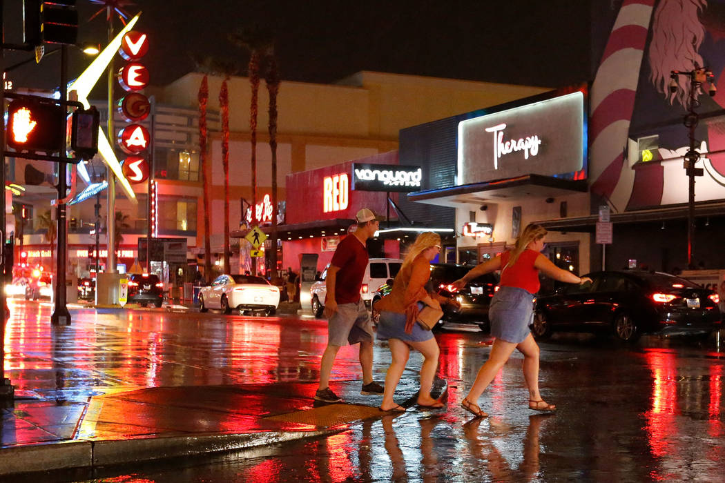 People run in the rain in downtown Las Vegas, Saturday, Aug. 11, 2018. Chitose Suzuki Las Vegas Review-Journal @chitosephoto
