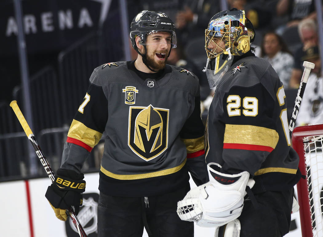 Golden Knights defenseman Shea Theodore (27) talks with goaltender Marc-Andre Fleury (29) during the second period of Game 3 of the NHL Western Conference finals hockey playoff series against the ...