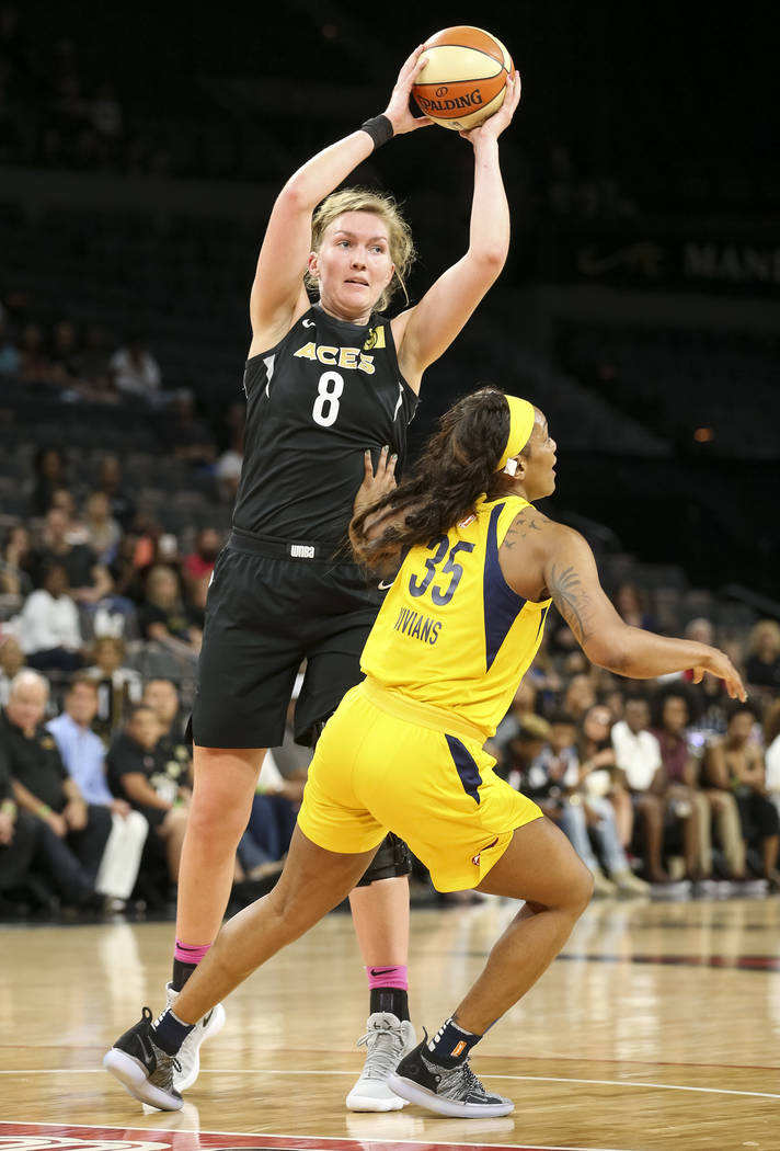 Las Vegas Aces center Carolyn Swords (8) passes the ball past Indiana Fever guard Victoria Vivians (35) during the first half of a WNBA basketball game at the Mandalay Bay Events Center on Saturda ...