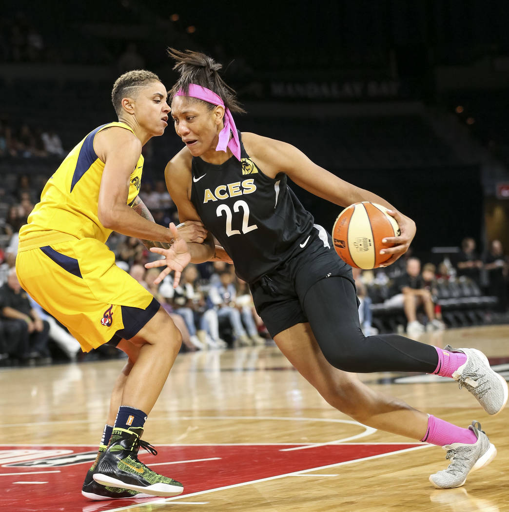 Las Vegas Aces center A'ja Wilson (22) drives the ball against Indiana Fever forward Candice Dupree (4) during the first half of a WNBA basketball game at the Mandalay Bay Events Center on Saturda ...