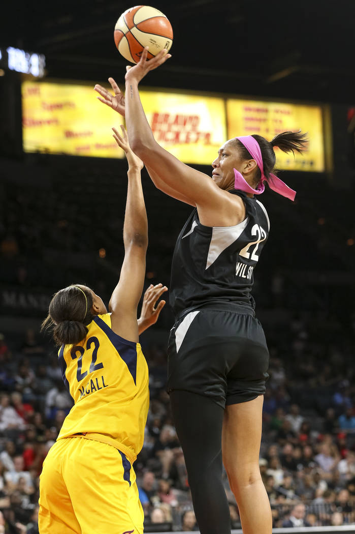 Las Vegas Aces center A'ja Wilson (22) shoots over Indiana Fever forward Erica McCall (22) during the second half of a WNBA basketball game at the Mandalay Bay Events Center on Saturday, Aug. 11, ...