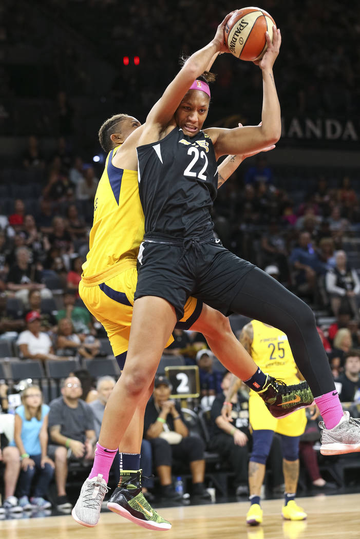 Las Vegas Aces center A'ja Wilson (22) pulls in the rebound over Indiana Fever forward Candice Dupree (4) during the first half of a WNBA basketball game at the Mandalay Bay Events Center on Satur ...