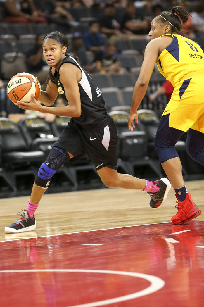 Las Vegas Aces guard Moriah Jefferson (4) drives the ball past Indiana Fever guard Kelsey Mitchell (0) during the first half of a WNBA basketball game at the Mandalay Bay Events Center on Saturday ...