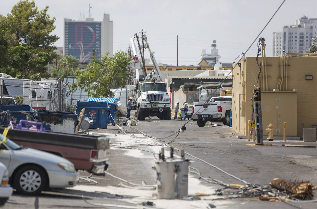 NV Energy crews work to restore power in the area of Fremont Street and Bruce Street on Sunday, Aug., 12, 2018, in Las Vegas. More than 60,000 people lost power Saturday night due to a severe thun ...