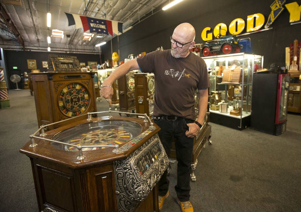 Don Grimmer, vice president of Morphy Auctions, demonstrates the Cailli Bros. 5 cent, 7-way roulette wheel slot machine on display at the company's warehouse located at 4520 Arville Street in Las ...