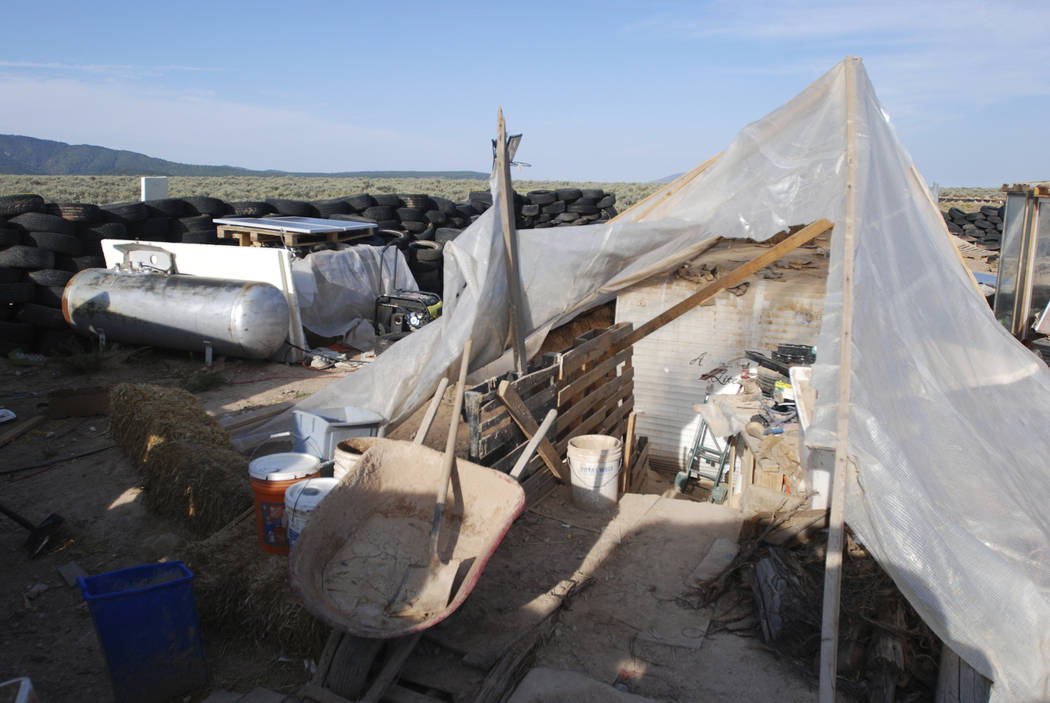 Various items litter a squalid makeshift living compound in Amalia, N.M., on Friday, Aug. 10, 2018, where five adults were arrested on child abuse charges and remains of a boy were found. The rema ...