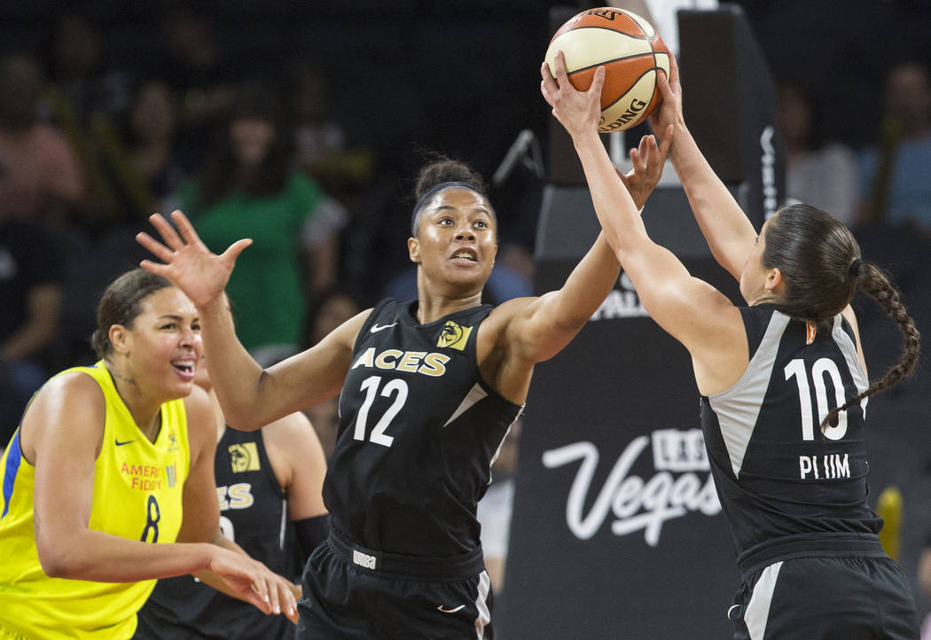 Aces forward Nia Coffey (12) and guard Kelsey Plum (10) reach for a loose ball in the 3rd quarter during their matchup with the Dallas Wings on Wednesday, June 27, 2018, at the Mandalay Bay Events ...