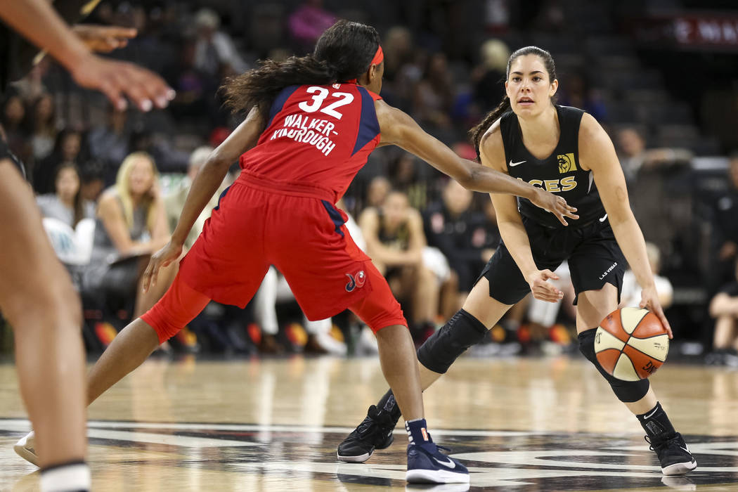 Las Vegas Aces guard Kelsey Plum (10) dribbles the ball as Washington Mystics guard Shatori Walker-Kimbrough (32) defends in the second half of a WNBA basketball game at the Mandalay Bay Events Ce ...