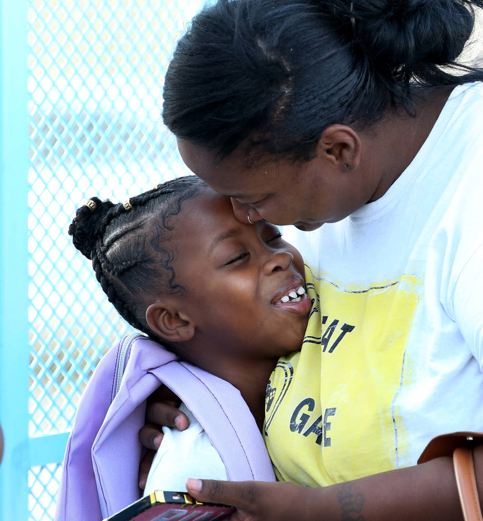 Chanell Wilson says goodbye to her daughter Constance Shabazz, 8, before she heads off to the first day of school at Kelly Elementary School on Monday, Aug. 13, 2018, in North Las Vegas. Bizuayehu ...