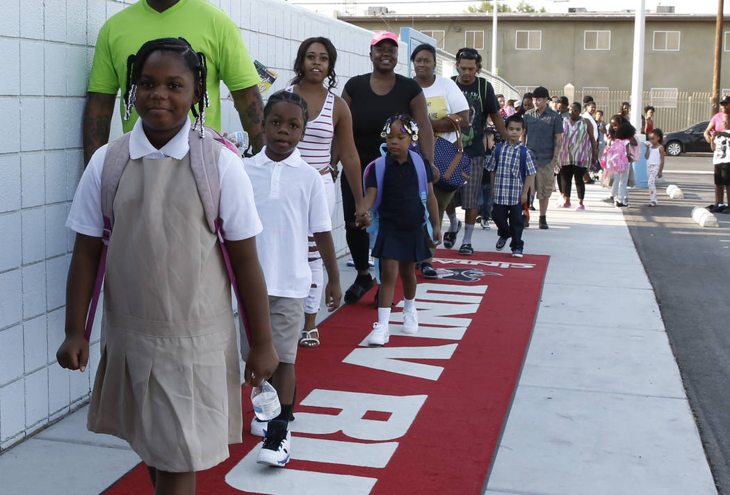 Matt Kelly Elementary School students and their parents walk on the red carpet as they arrive on the first day of school on Monday, Aug. 13, 2018, in North Las Vegas. Bizuayehu Tesfaye/Las Vegas R ...