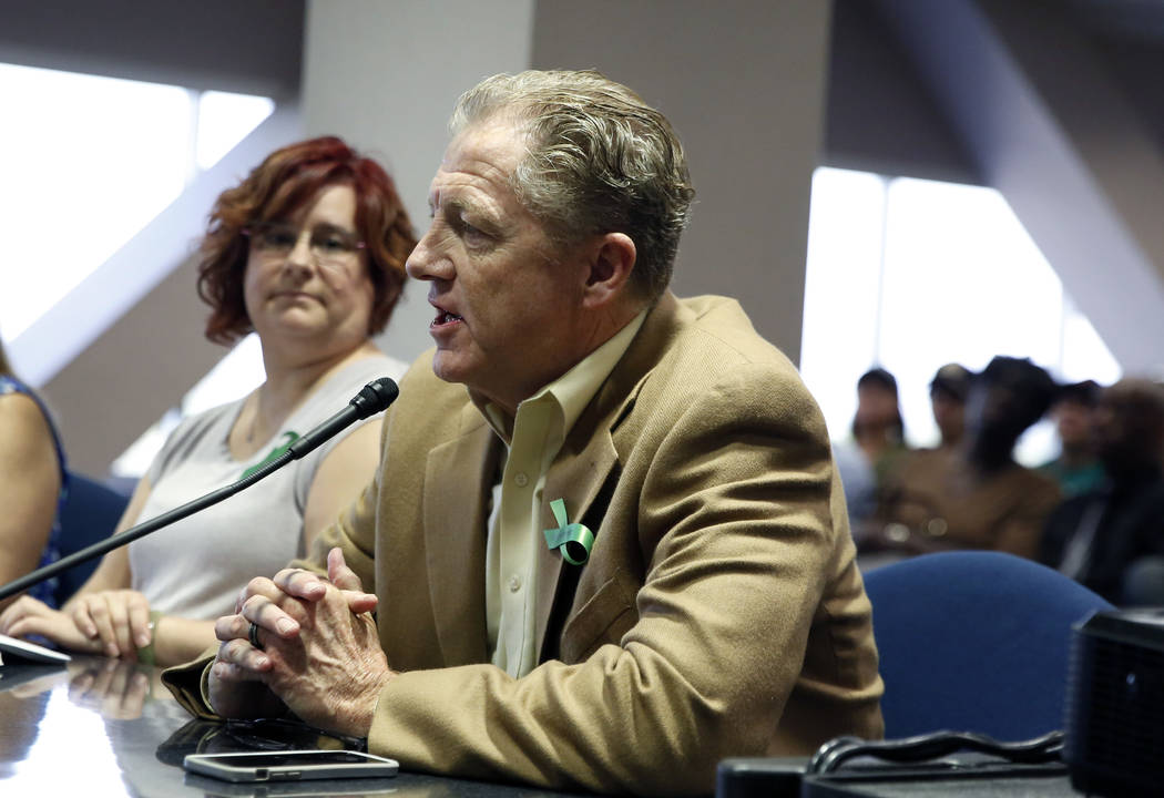 Clark County Children's Mental Health Consortium Chair, Dan Musgrove, speaks as Jer Roberson-Strange, left, individual and family therapist, looks on during a public hearing at the Grant Sawyer St ...