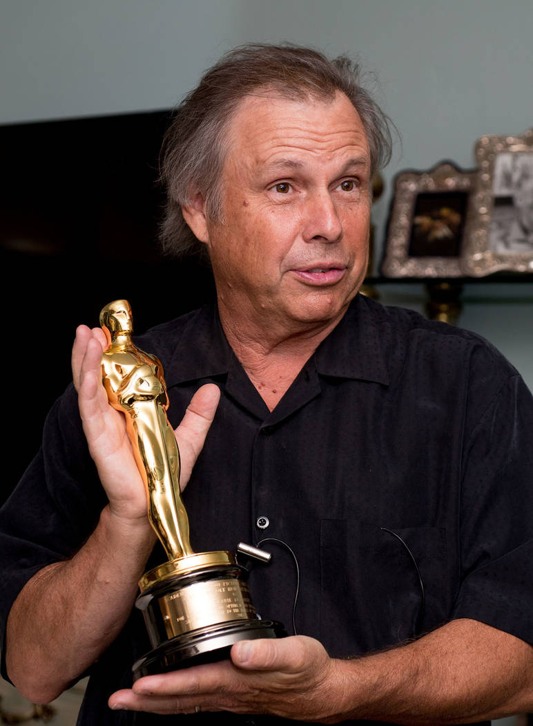Todd Fisher holds his mother's, Debbie Reynolds, Academy Award.