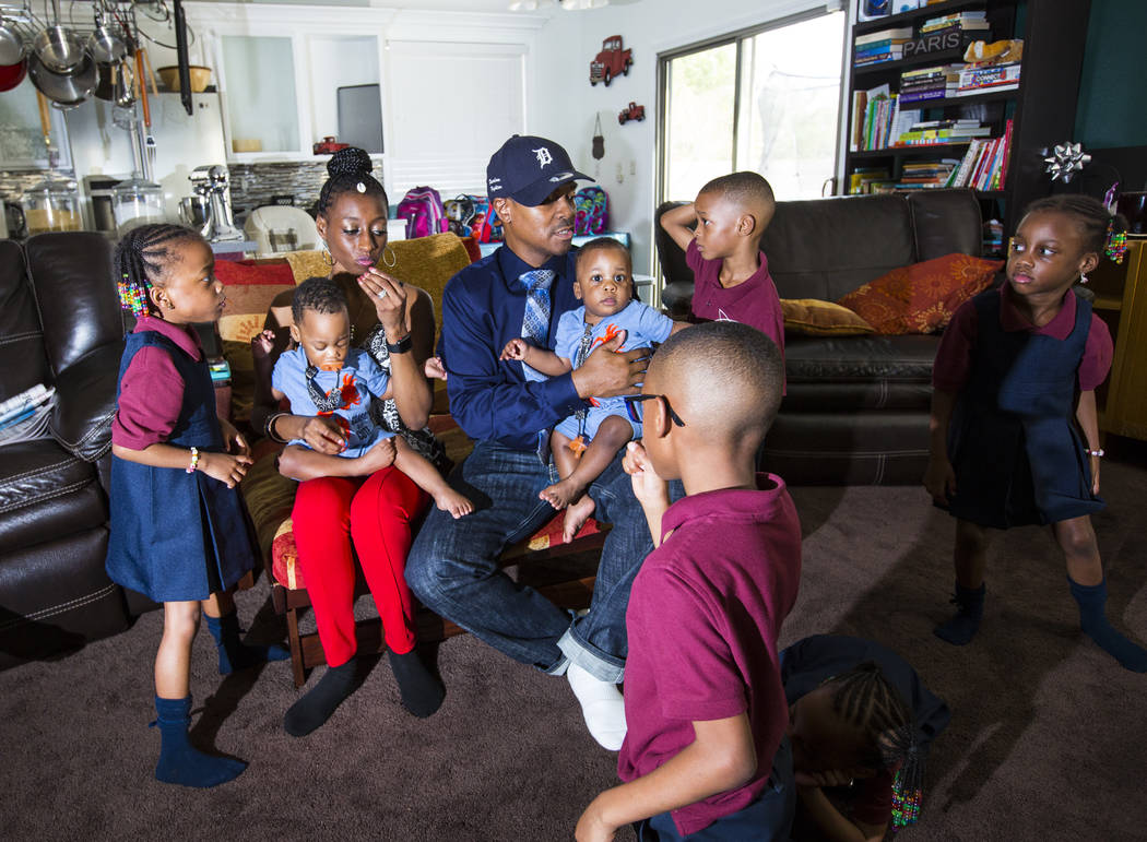 Deon Derrico, center, with wife, Karen Evonne Derrico, and some of their 11 children before posing for a family photo at their home in North Las Vegas on Wednesday, Aug. 15, 2018. Chase Stevens La ...