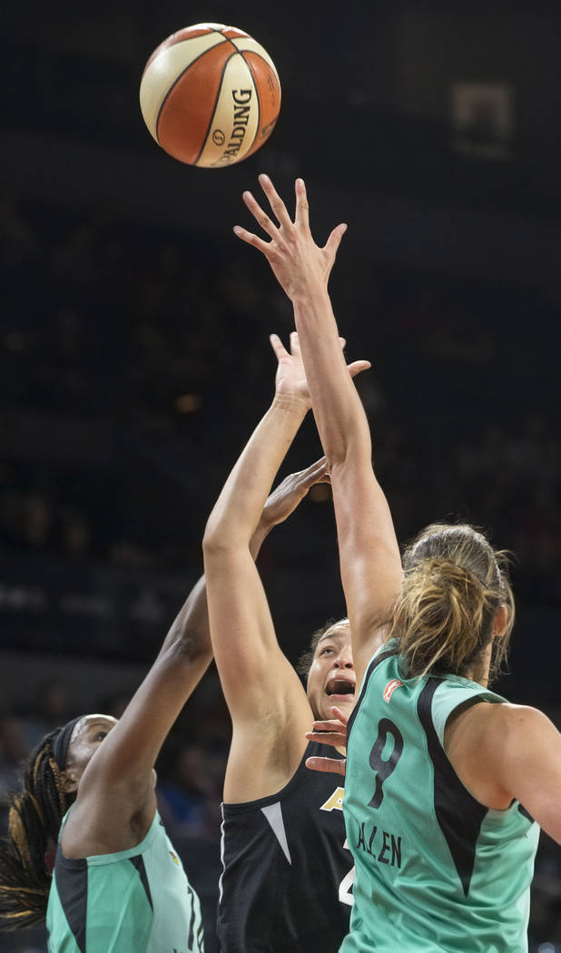 Aces guard Kayla McBride (21) shoots over New York Liberty defenders Rebecca Allen (9) and Sugar Rodgers (14) in the fourth quarter on Wednesday, Aug. 15, 2018, at the Mandalay Bay Events Center, ...