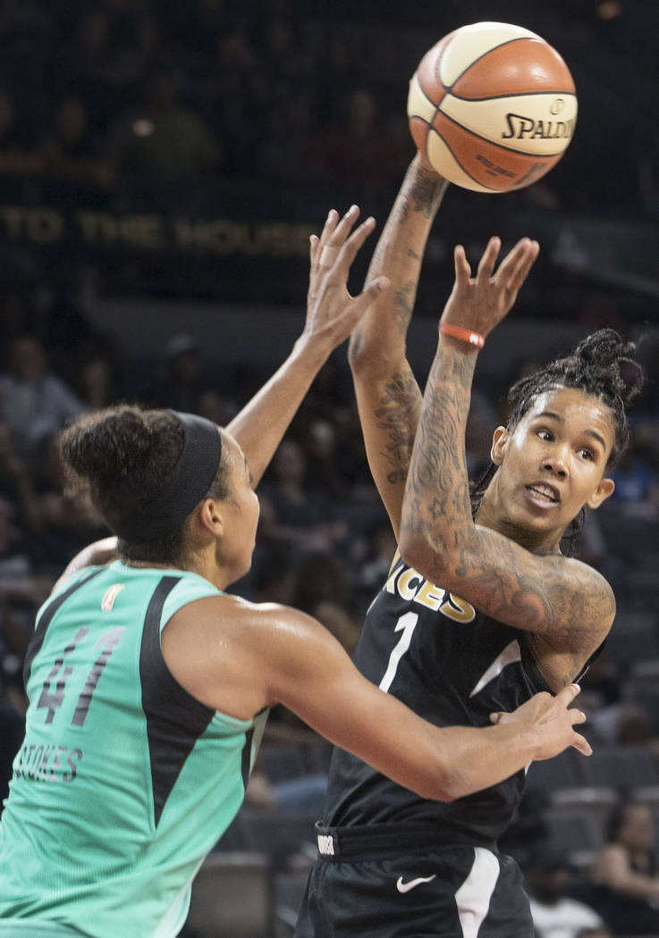 Aces forward Tamera Young (1) makes a pass over New York Liberty guard Kiah Stokes (41) in the fourth quarter on Wednesday, Aug. 15, 2018, at the Mandalay Bay Events Center, in Las Vegas. Benjamin ...