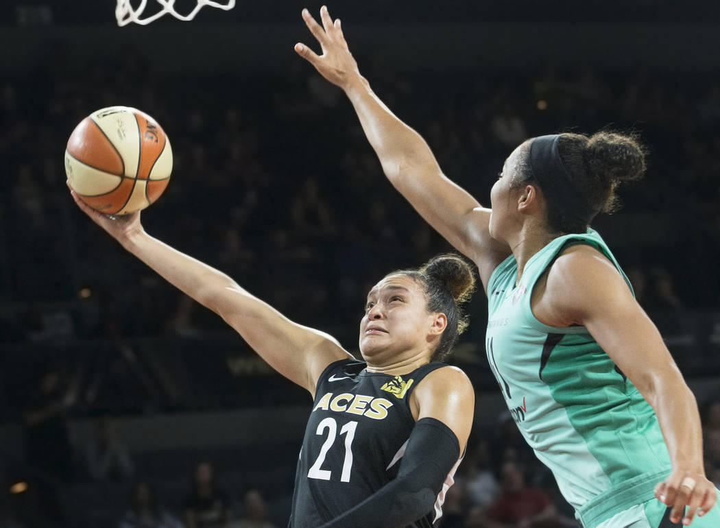 Aces guard Kayla McBride (21) drives past New York Liberty guard Kiah Stokes (41) in the fourth quarter on Wednesday, Aug. 15, 2018, at the Mandalay Bay Events Center, in Las Vegas. Benjamin Hager ...