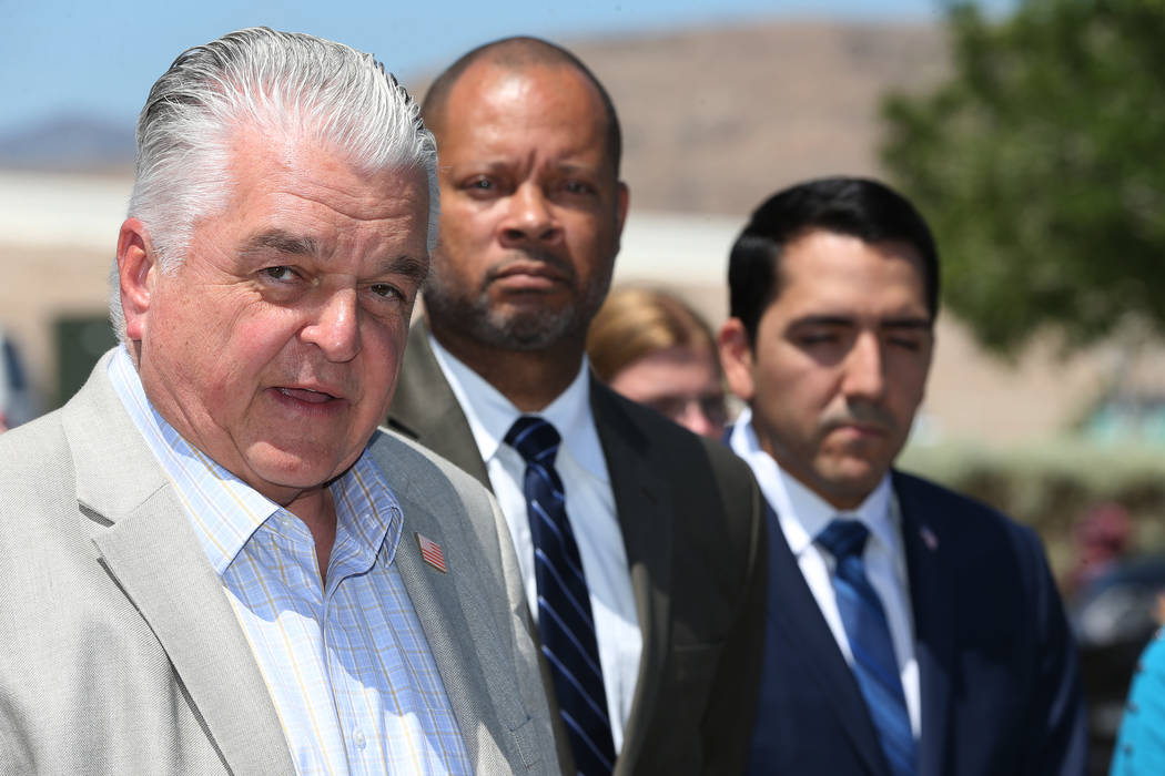 Clark County Commissioner Steve Sisolak, left, Senate Majority Leader Aaron Ford and Assemblyman Nelson Araujo speak during a rally hosted by the Nevada Democrats and NARAL to protest the Supreme ...
