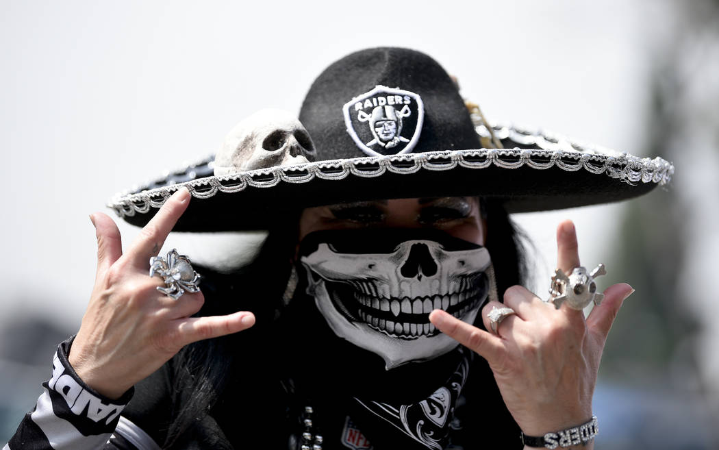A Oakland Raider fan poses before an NFL preseason football game against the Los Angeles Rams Saturday, Aug. 18, 2018, in Los Angeles. (AP Photo/Kelvin Kuo)