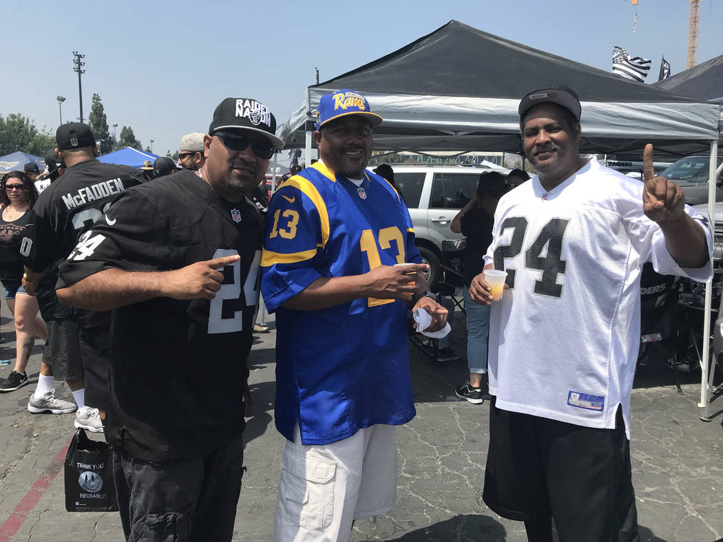 Benard Young (right) and friends tailgate before Raiders-Rams game in Los Angeles on Saturday. (Gilbert Manzano)