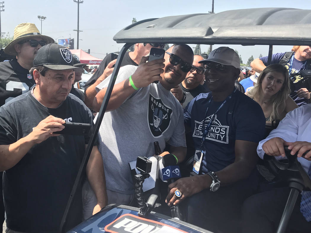 Rams legend Eric Dickerson takes picture with Raiders fans on Saturday. (Gilbert Manzano)